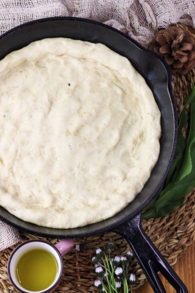 image of pizza dough placed in a pan